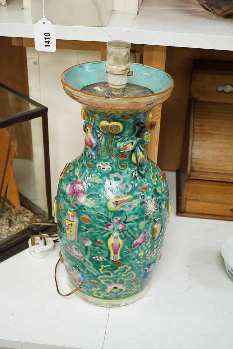 A late 19th century Chinese enamelled porcelain green ground vase with relief decoration, mounted as a lamp, 48cm high overall